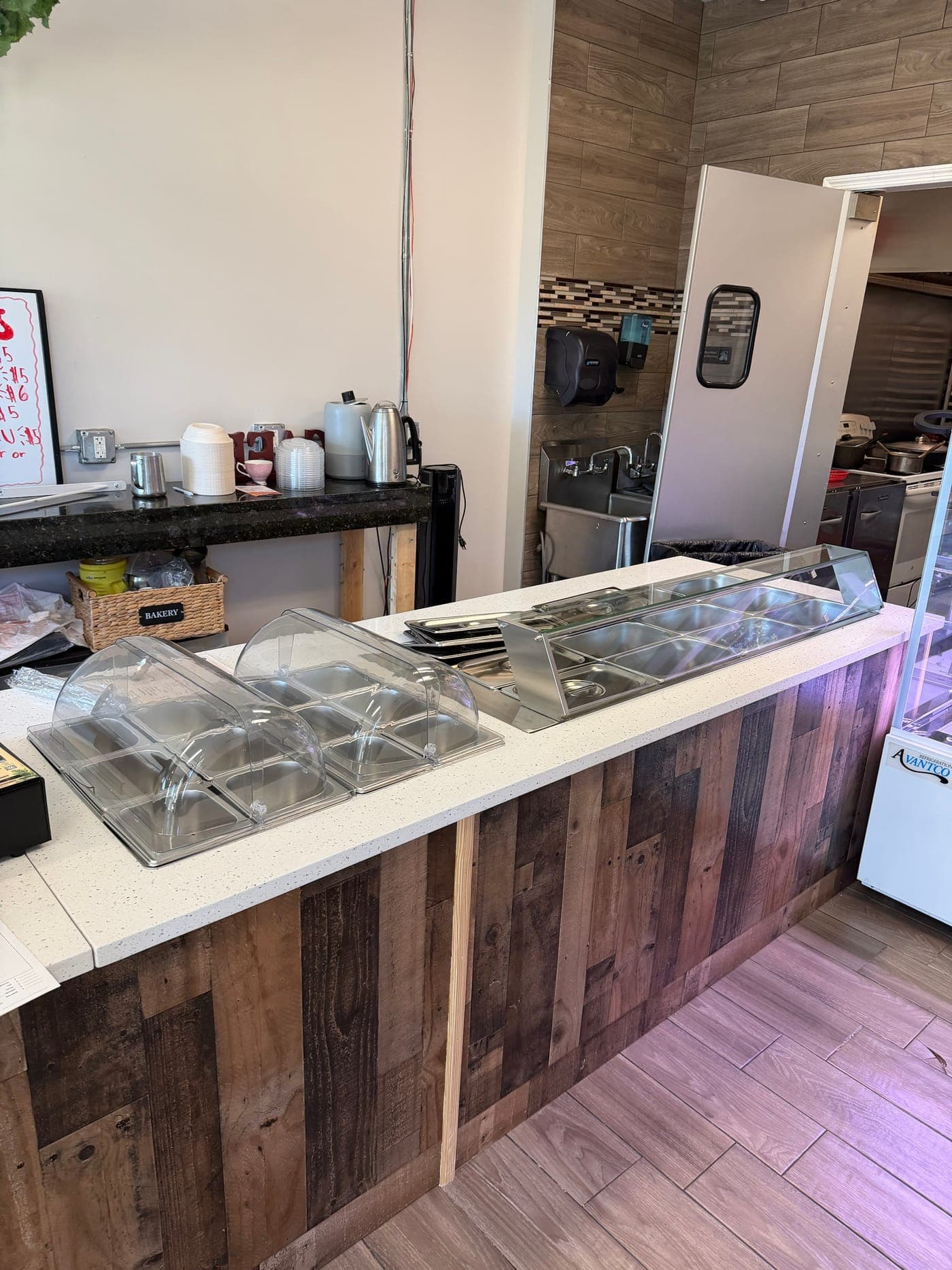 The same restaurant counter before: plastic roll-top covers and a stock stainless guard